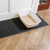 Black mesh runner rug sits under litter box